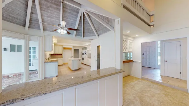 a bathroom with a toilet and a painting on the wall