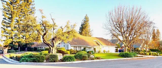 a kitchen with stainless steel appliances granite countertop a sink and a white cabinets