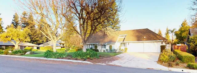 a kitchen with stainless steel appliances kitchen island granite countertop a sink and a stove top oven