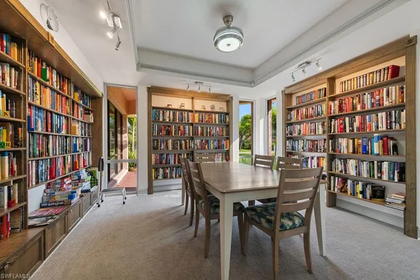 a view of a dining room with furniture and a bookshelf