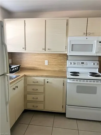a kitchen with cabinets stainless steel appliances and sink