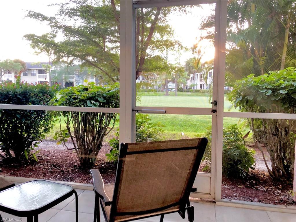 180 Turtle Lake Court, Unit 106 Naples, FL 34105 - Photo 8 of 17 a view of a chair and table in the patio
