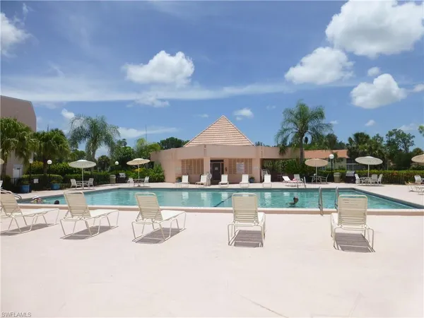 a view of a swimming pool with a table and chairs
