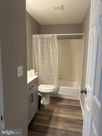 a bathroom with a sink a toilet and a shower