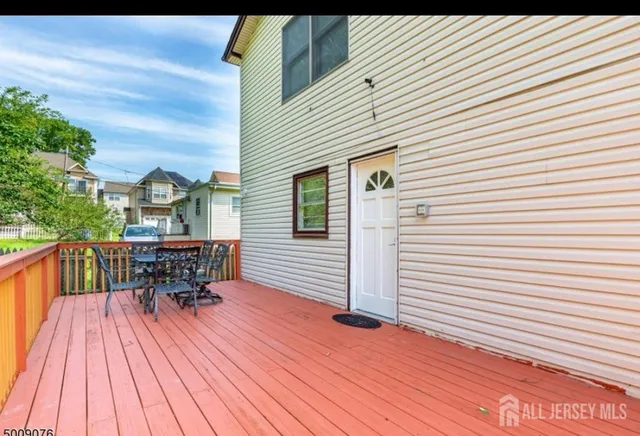 a view of balcony with dining table and chairs
