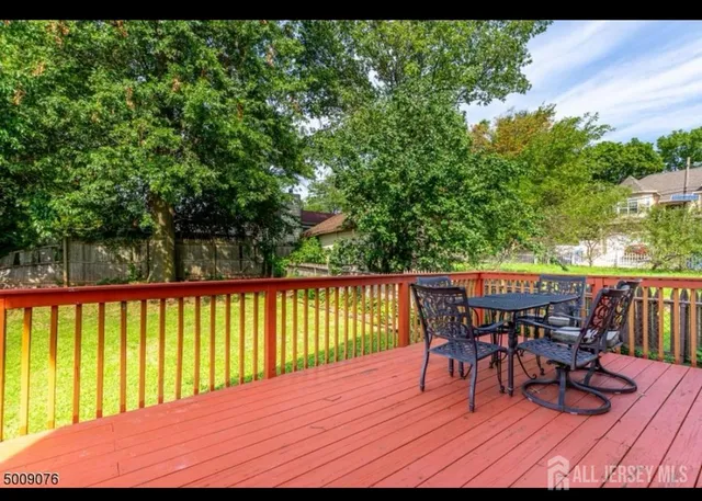 a view of a backyard with wooden fence