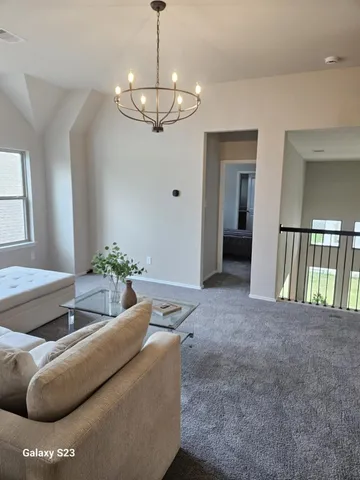 a living room with furniture and a chandelier