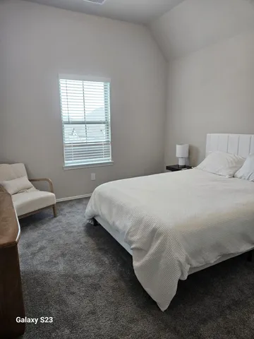 a bedroom with a bed and window