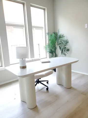 a room with a table and a potted plant