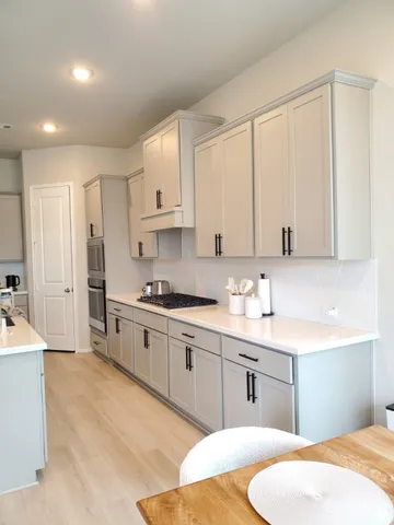 a kitchen with stainless steel appliances granite countertop a sink a stove and a refrigerator