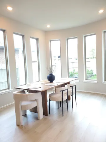 a view of a work space with furniture and windows