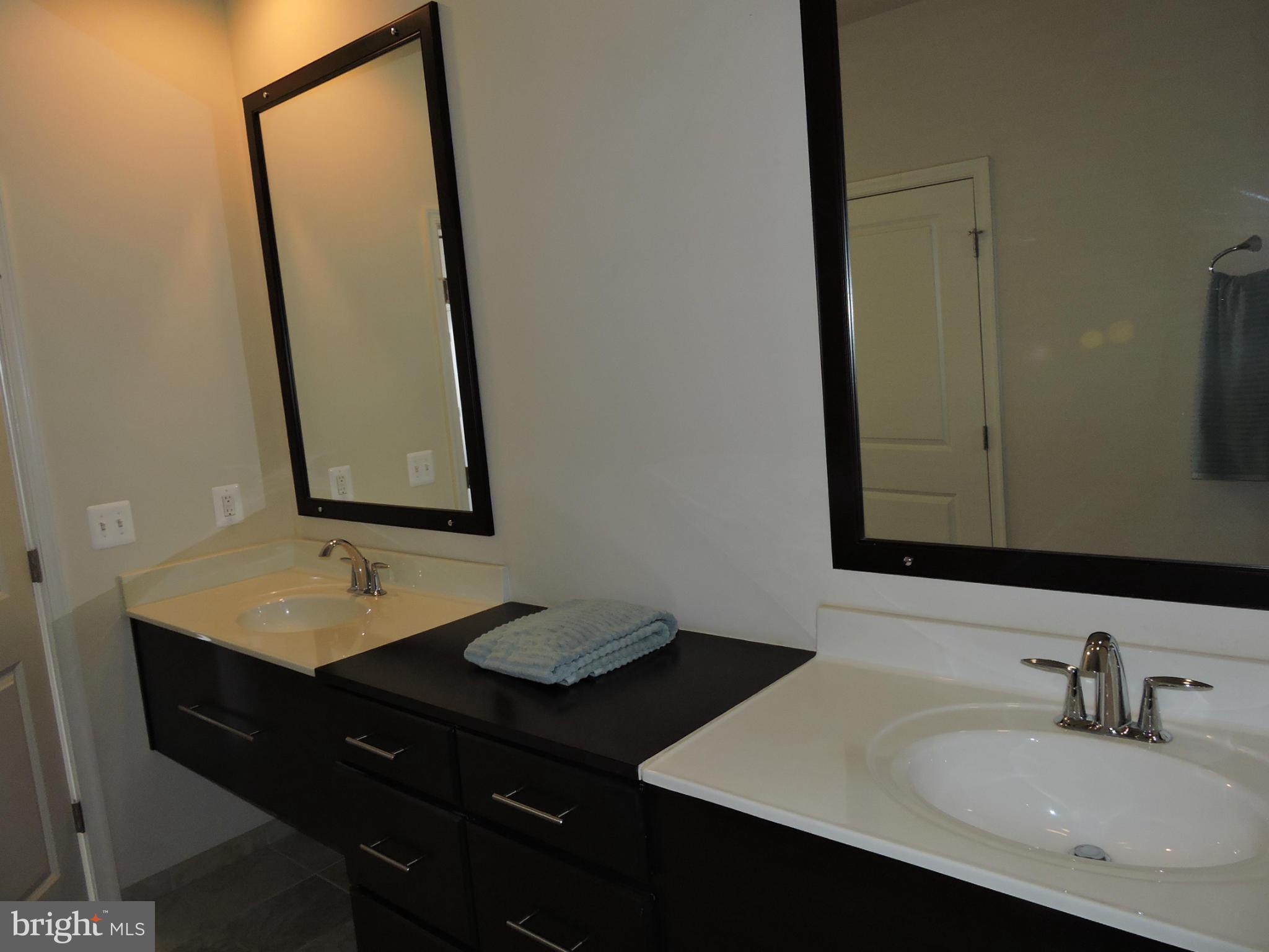 20425 Codman Drive Ashburn, VA 20147 - Photo 15 of 36 a bathroom with a sink vanity and a mirror
