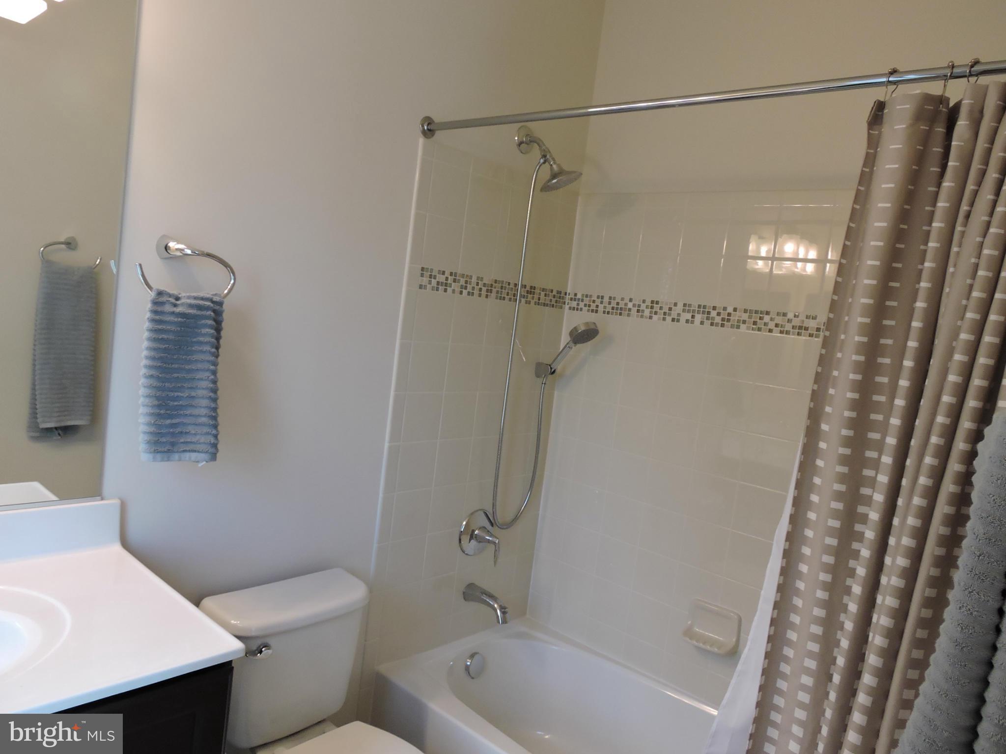 20425 Codman Drive Ashburn, VA 20147 - Photo 16 of 36 a bathroom with a shower a toilet and a sink