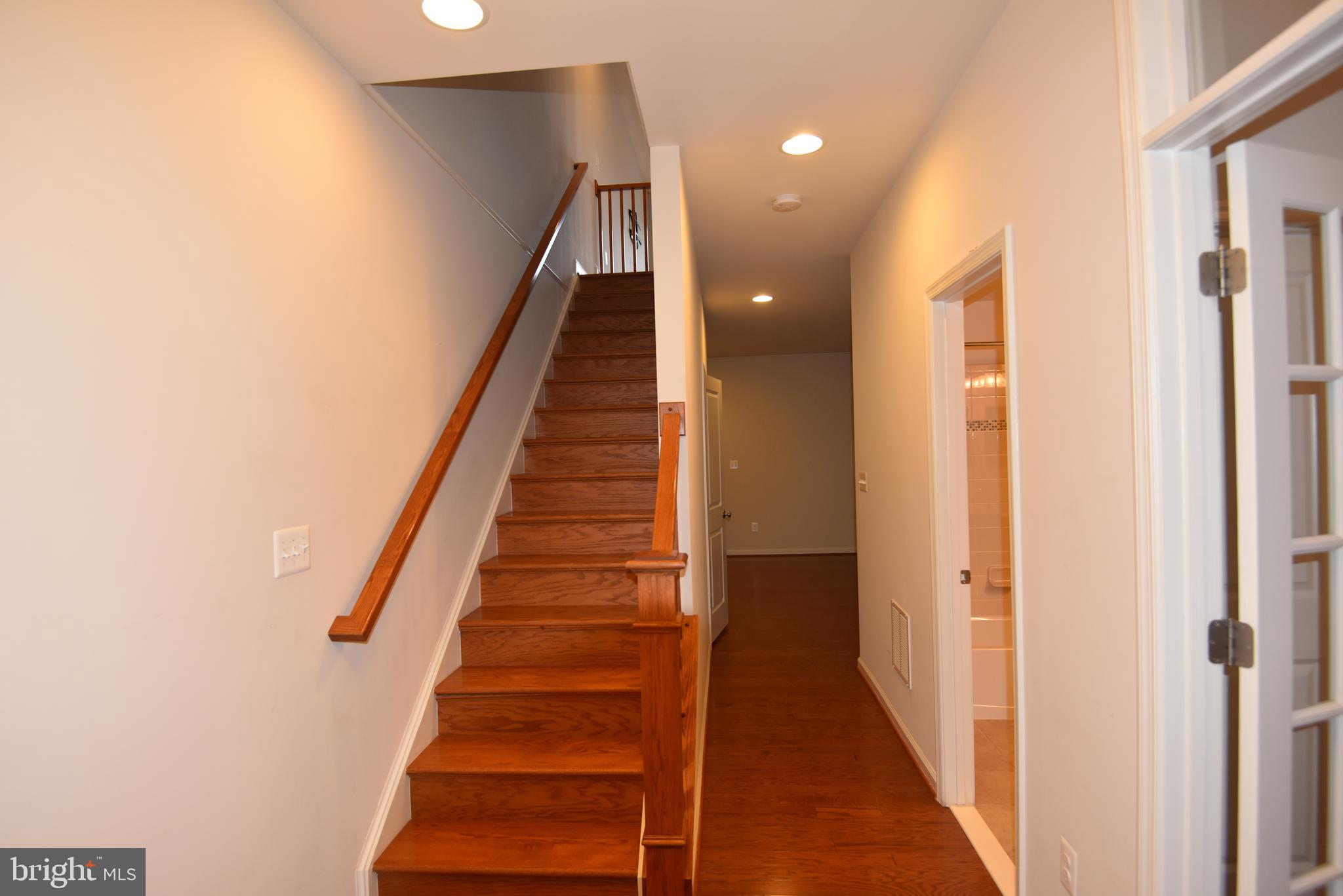 20425 Codman Drive Ashburn, VA 20147 - Photo 17 of 36 a view of entryway and gallery with wooden floor