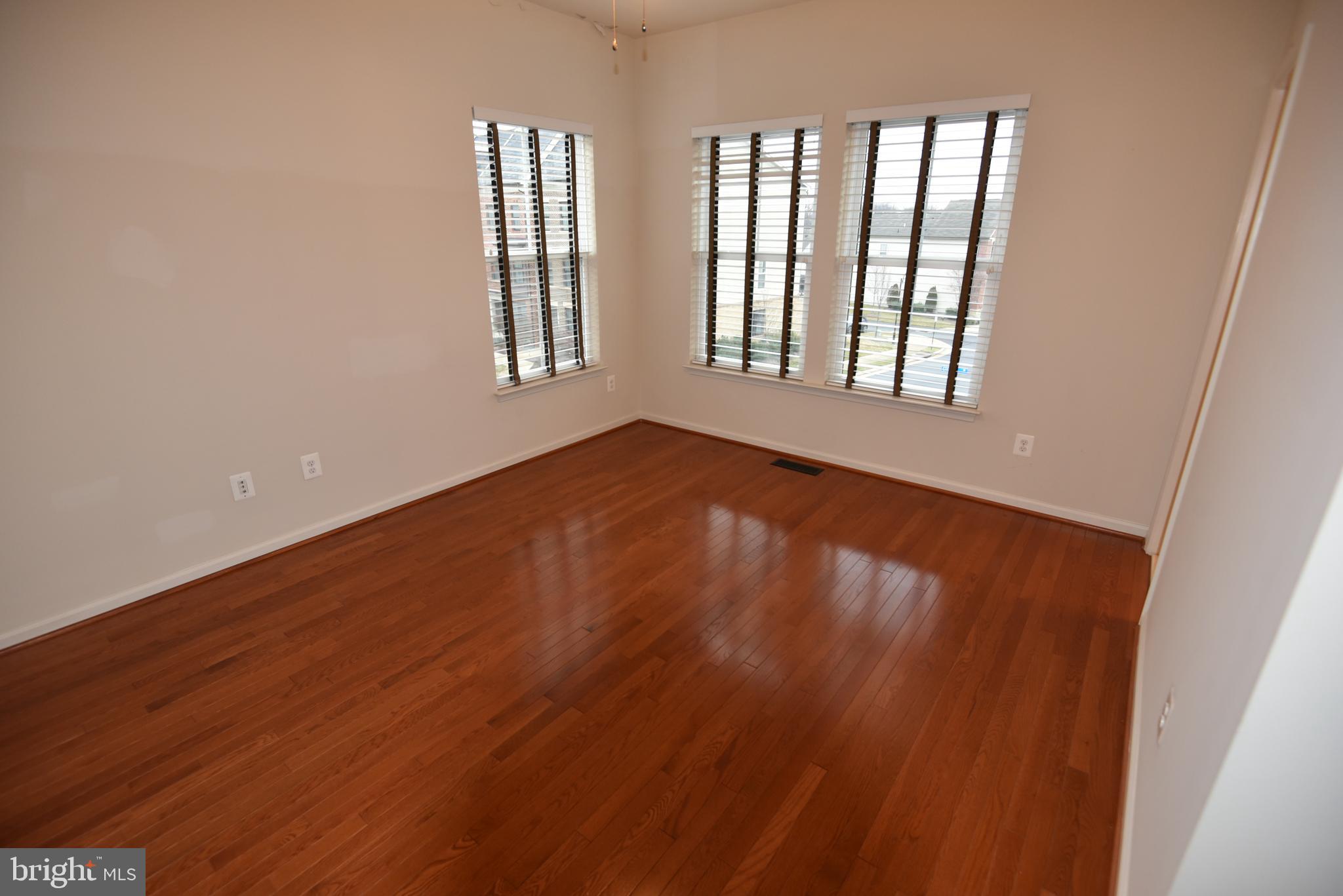 20425 Codman Drive Ashburn, VA 20147 - Photo 18 of 36 a view of an empty room with wooden floor and windows