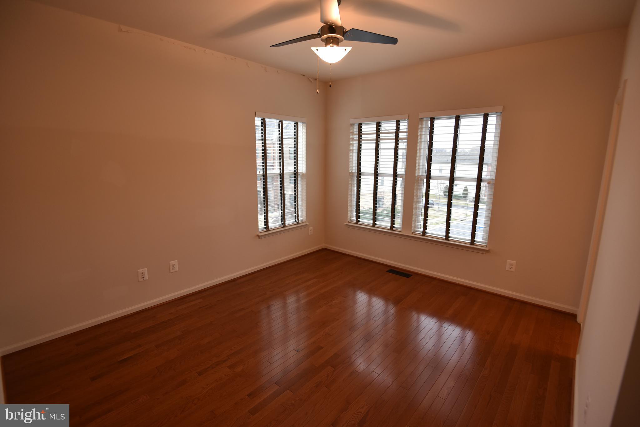 20425 Codman Drive Ashburn, VA 20147 - Photo 19 of 36 a view of an empty room with a window and wooden floor