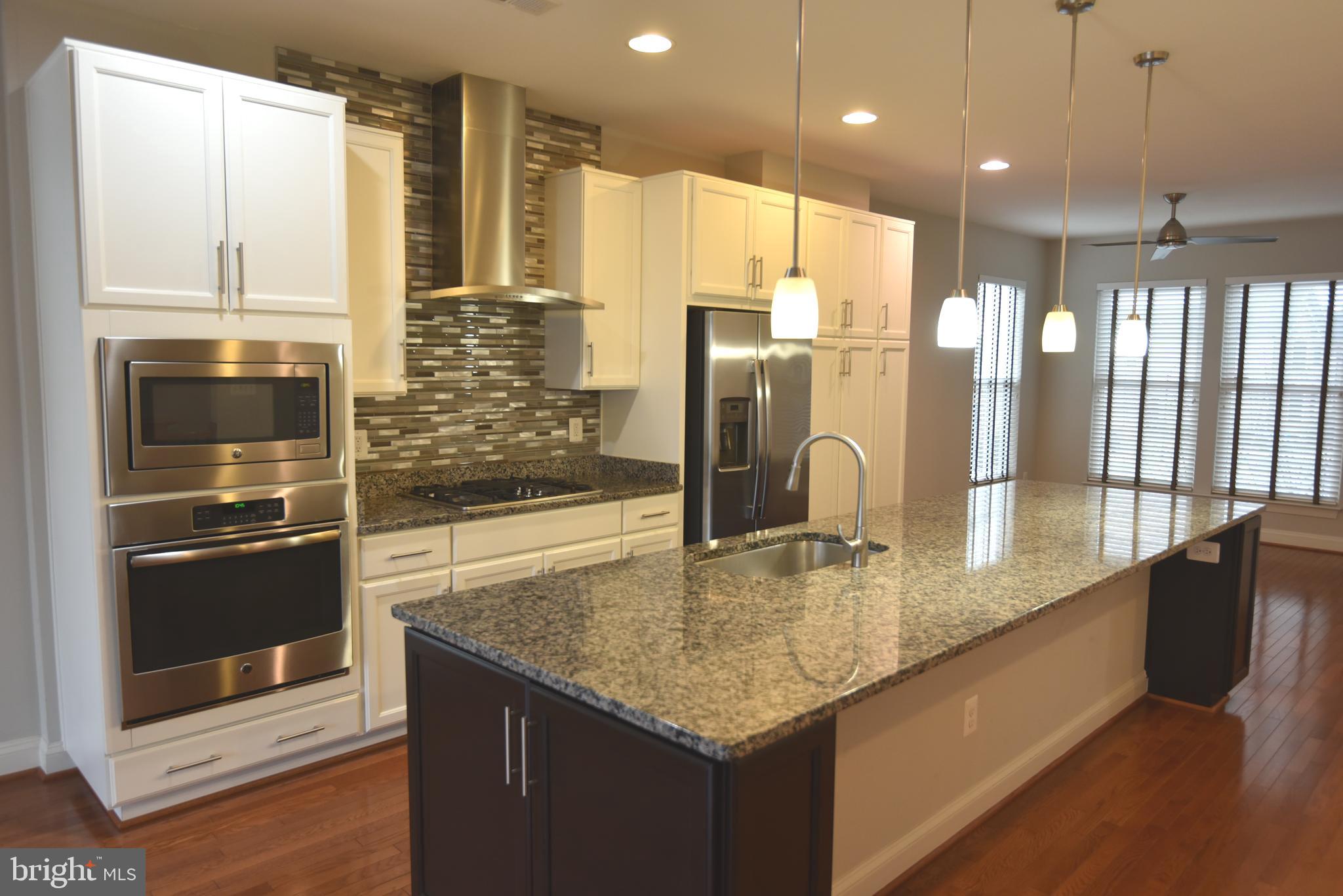 20425 Codman Drive Ashburn, VA 20147 - Photo 2 of 36 a kitchen with stainless steel appliances granite countertop a refrigerator a oven and a sink