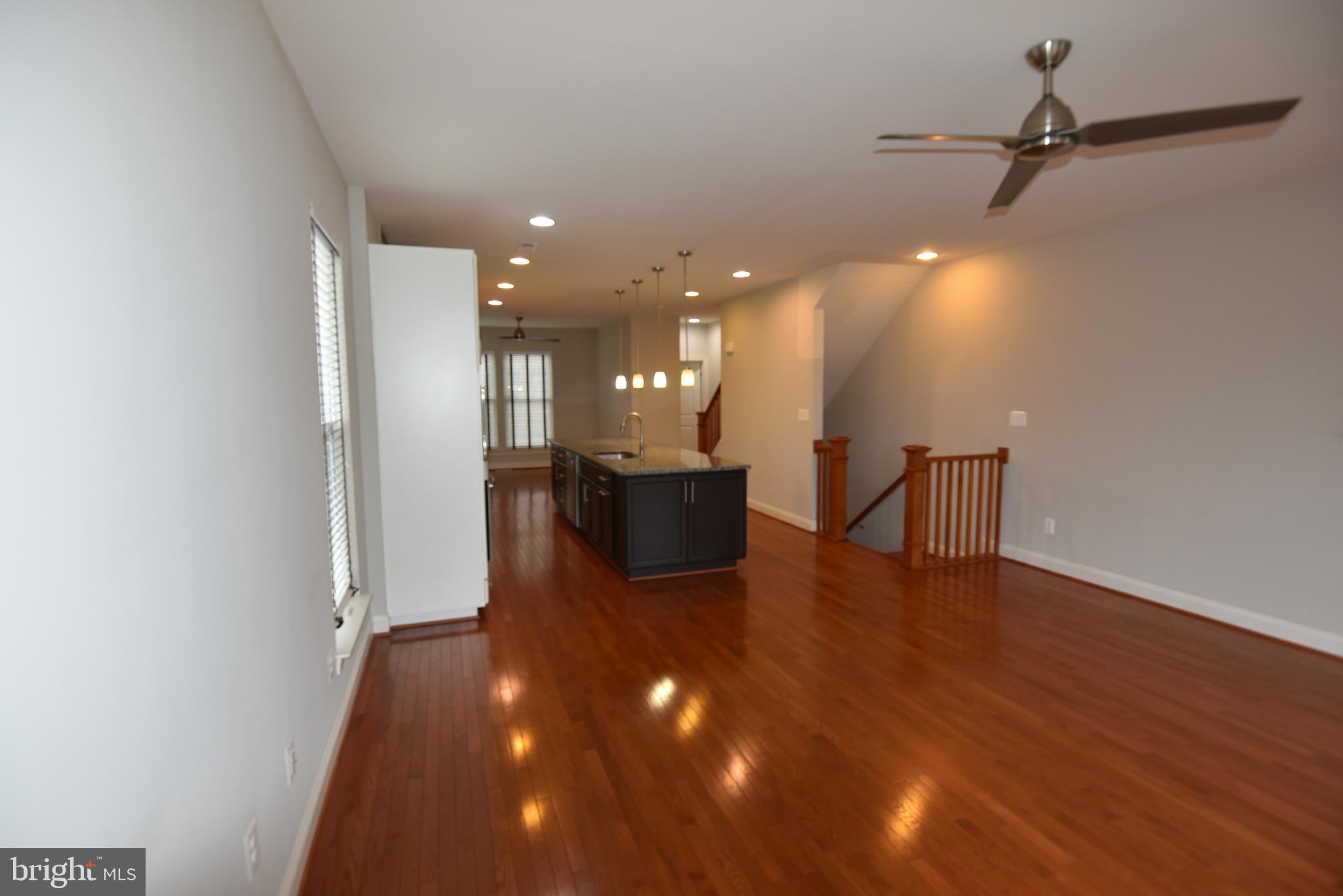 20425 Codman Drive Ashburn, VA 20147 - Photo 25 of 36 a view of a living room a kitchen and a wooden floor