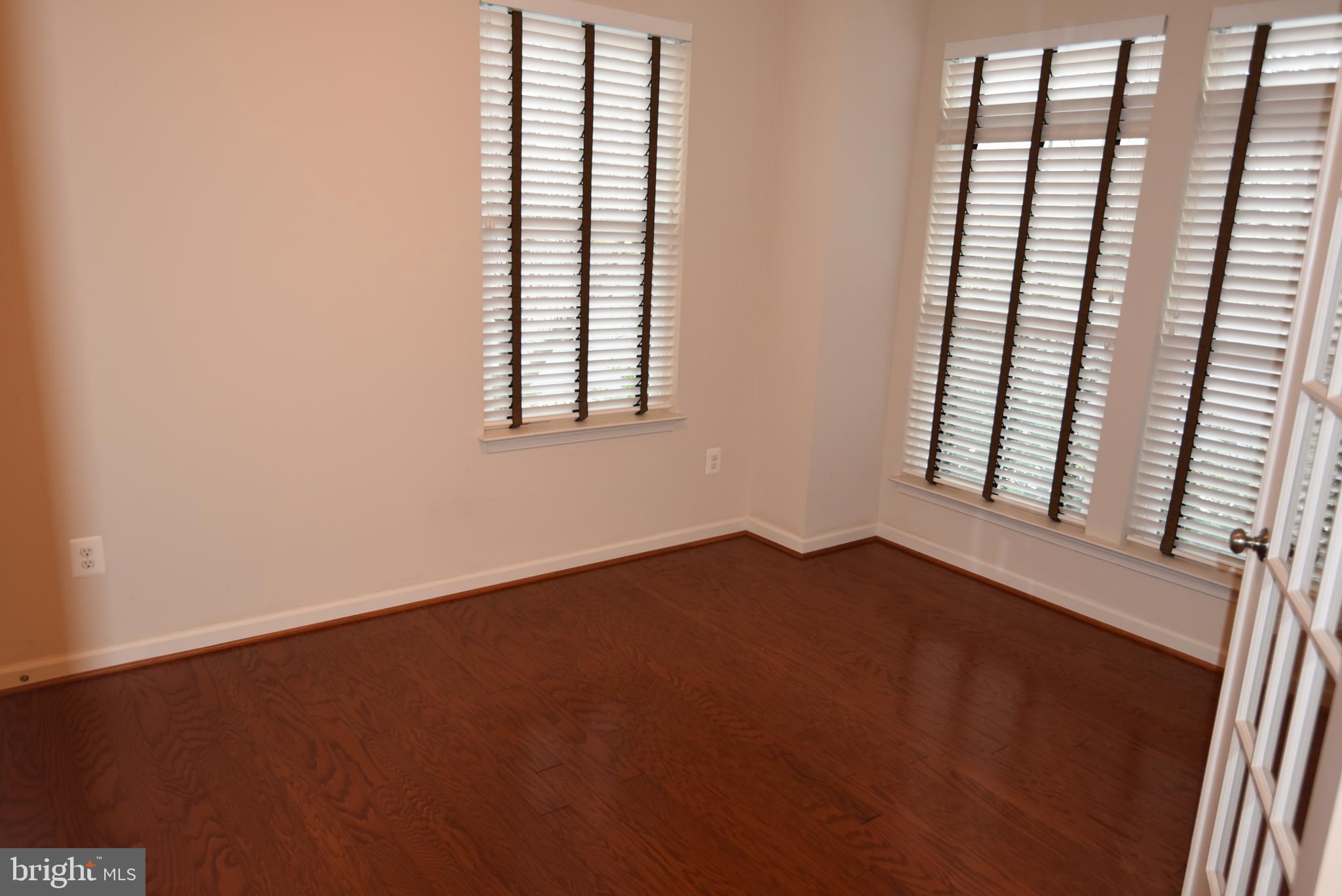 20425 Codman Drive Ashburn, VA 20147 - Photo 30 of 36 an empty room with wooden floor and windows