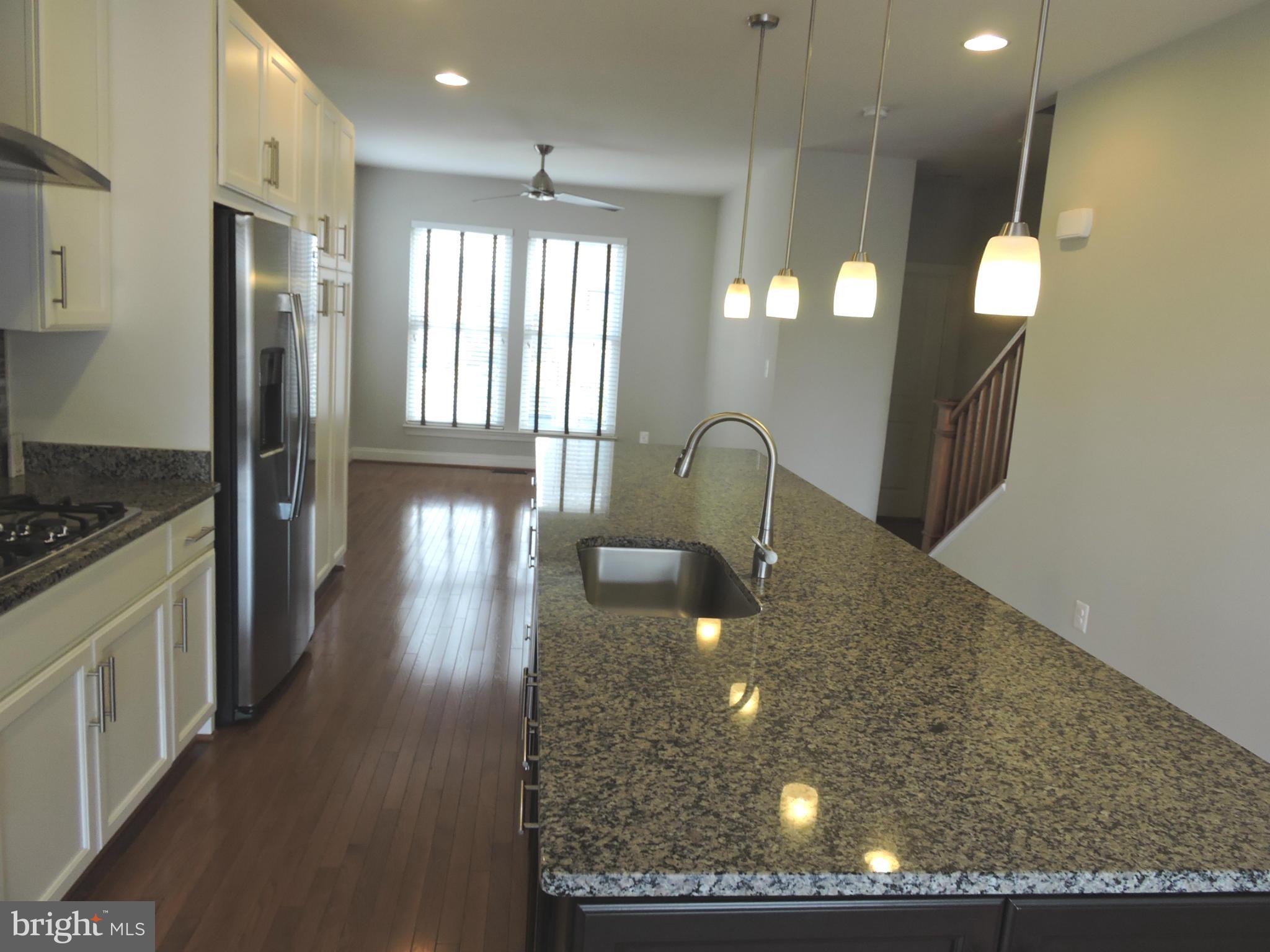 20425 Codman Drive Ashburn, VA 20147 - Photo 3 of 36 a kitchen with counter top space and wooden floor