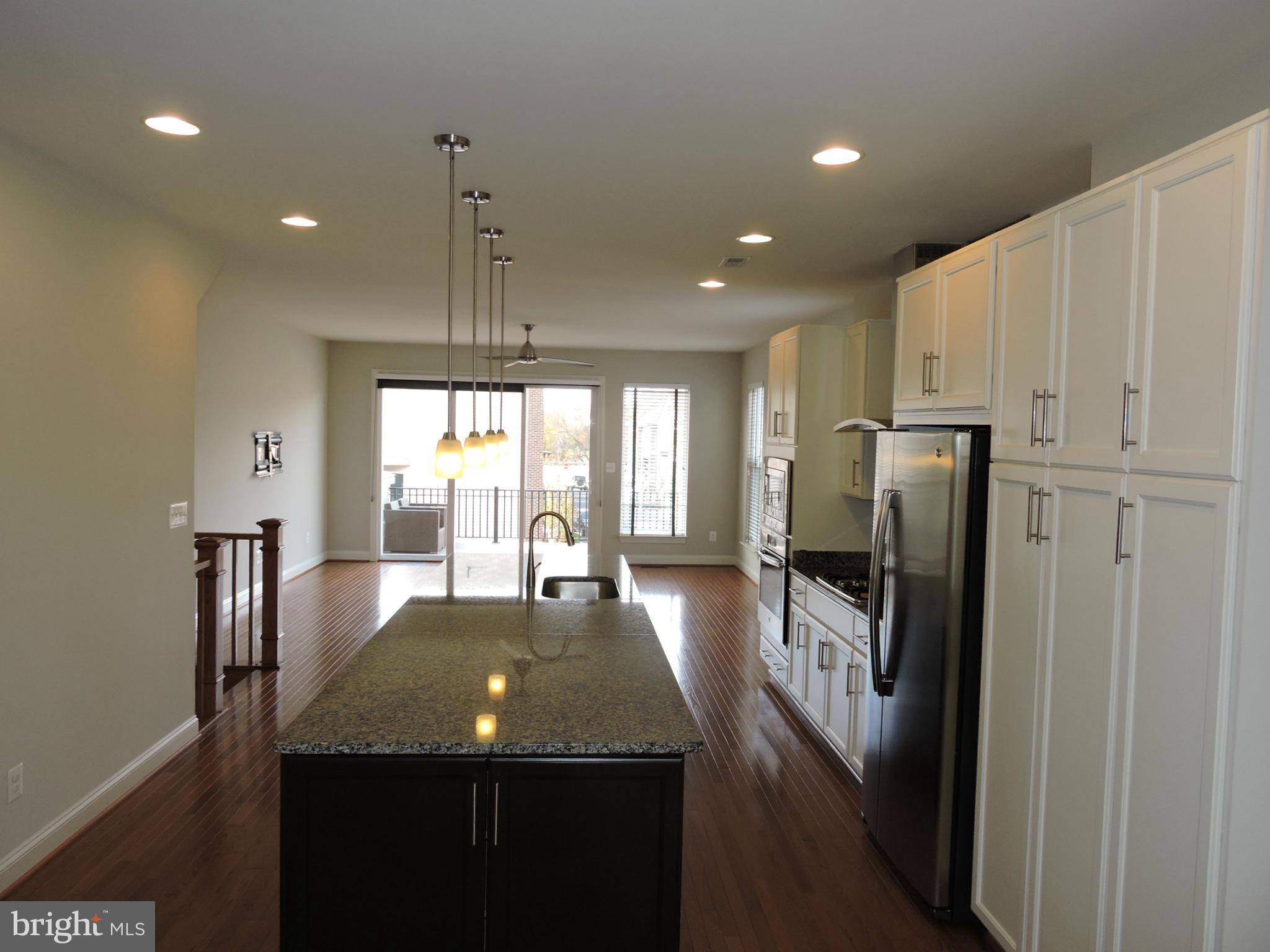 20425 Codman Drive Ashburn, VA 20147 - Photo 7 of 36 a kitchen with refrigerator a stove and a view of dining room