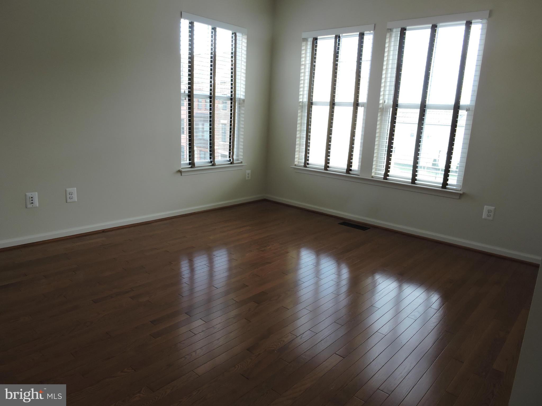 20425 Codman Drive Ashburn, VA 20147 - Photo 10 of 36 a view of an empty room with wooden floor and a window