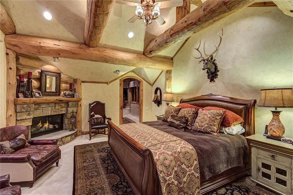 56 Rounds Road Breckenridge, CO 80424 - Photo 21 of 35 a bedroom with a bed and a fireplace