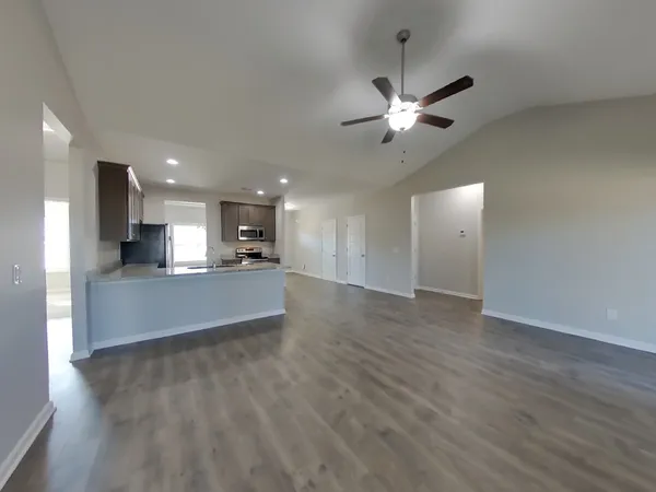 a view of kitchen with sink and wooden floor