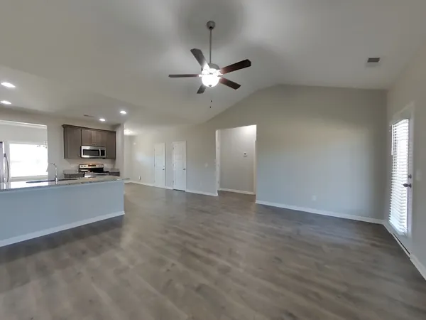 a view of kitchen with refrigerator and window