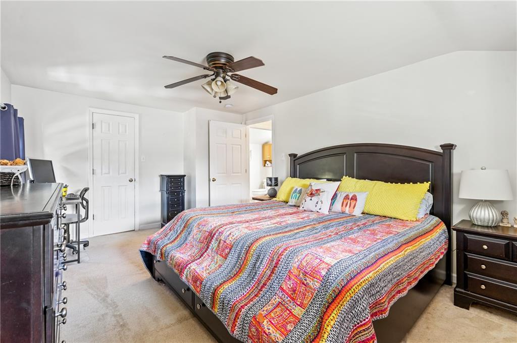 3702 Colby Street Pittsburgh, PA 15214 - Photo 12 of 21 a bedroom with a bed a chandelier and dresser