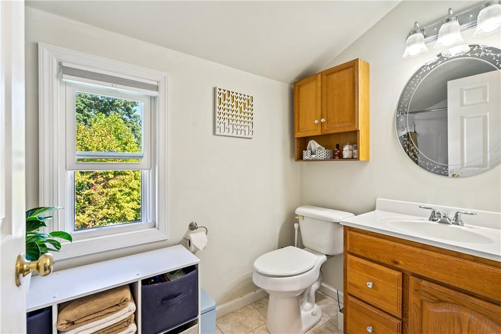 3702 Colby Street Pittsburgh, PA 15214 - Photo 15 of 21 a bathroom with a toilet a sink and a mirror