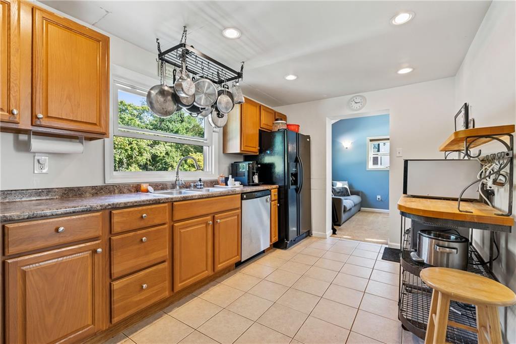 3702 Colby Street Pittsburgh, PA 15214 - Photo 6 of 21 a kitchen with stainless steel appliances granite countertop a sink and a refrigerator