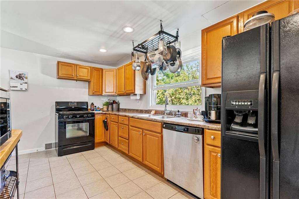 3702 Colby Street Pittsburgh, PA 15214 - Photo 7 of 21 a kitchen with stainless steel appliances granite countertop a refrigerator and a stove top oven