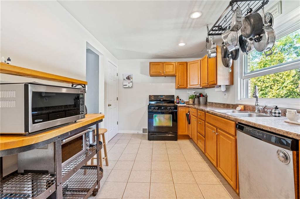 3702 Colby Street Pittsburgh, PA 15214 - Photo 8 of 21 a kitchen with stainless steel appliances a stove sink and microwave