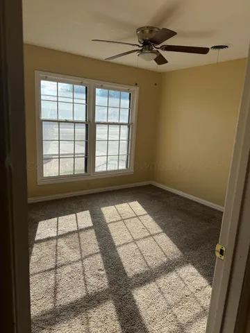 a bathroom with a granite countertop toilet sink and mirror