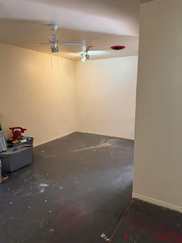 a view of a yard with wooden fence