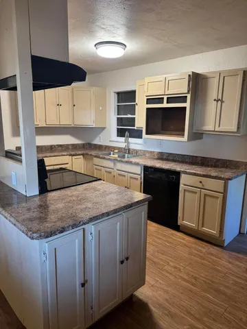 a kitchen with stainless steel appliances granite countertop a sink stove and microwave