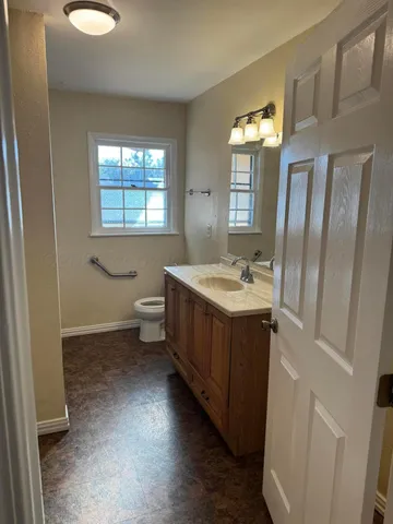 a bathroom with a double vanity sink toilet and shower
