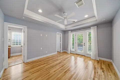 a view of room with wooden floor and front door