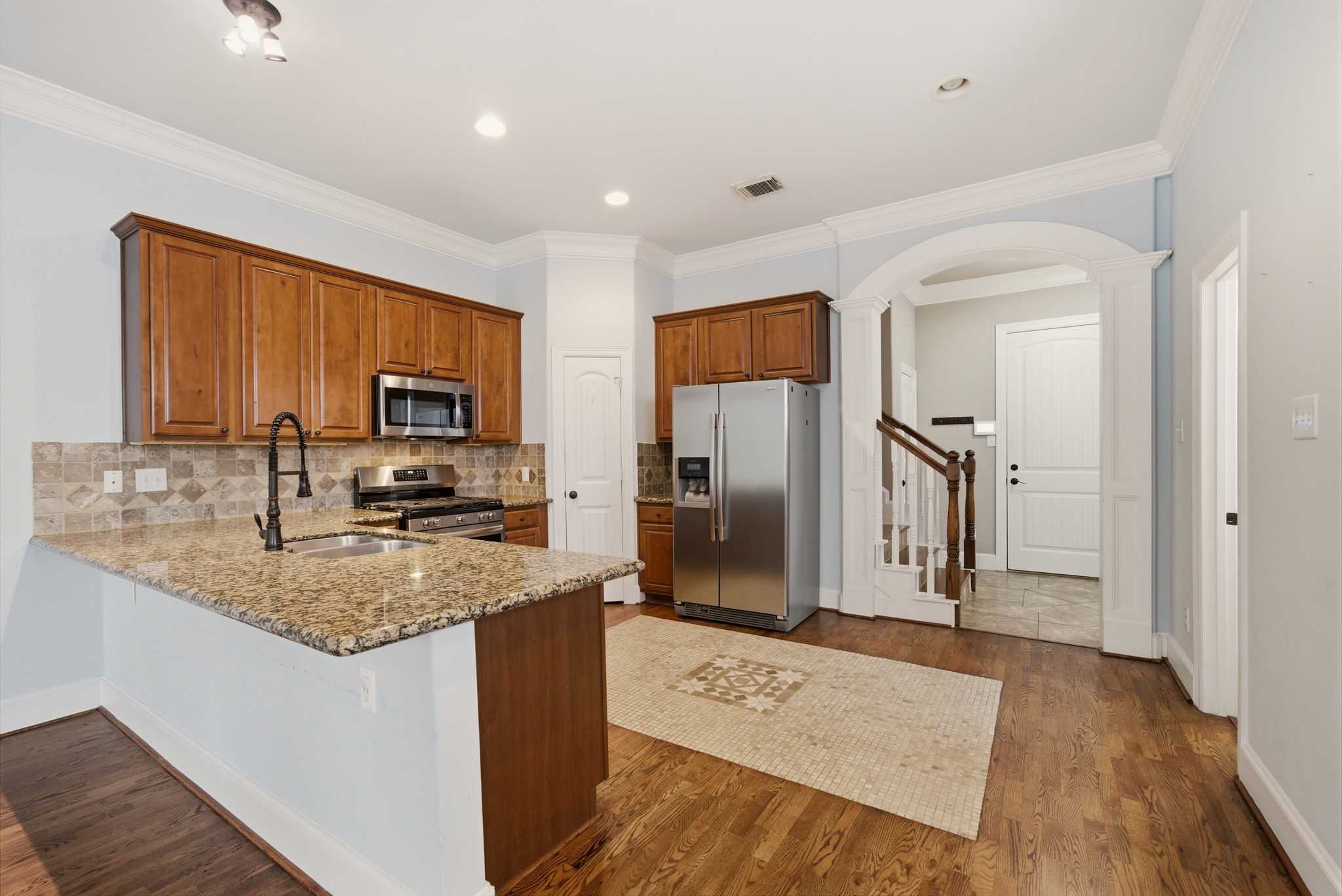 1007 Kern Street Houston, TX 77009 - Photo 7 of 35 a kitchen with stainless steel appliances granite countertop a refrigerator a stove top oven a sink and dishwasher