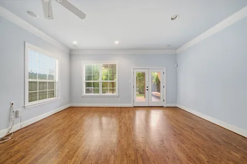 wooden floor in an empty room with a window