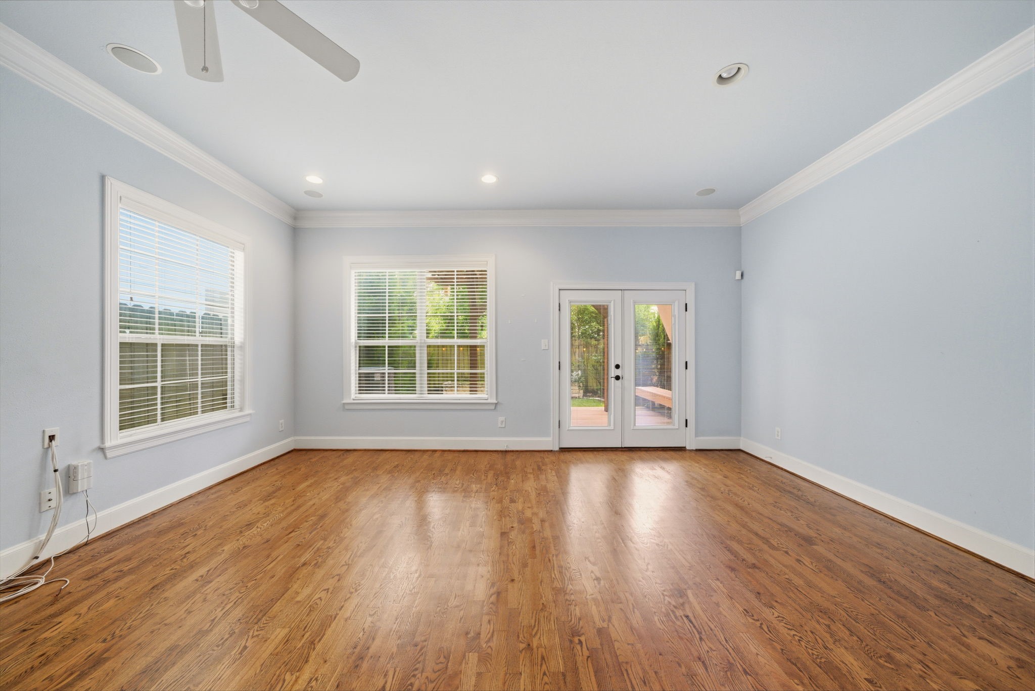 1007 Kern Street Houston, TX 77009 - Photo 9 of 35 an empty room with wooden floor and windows