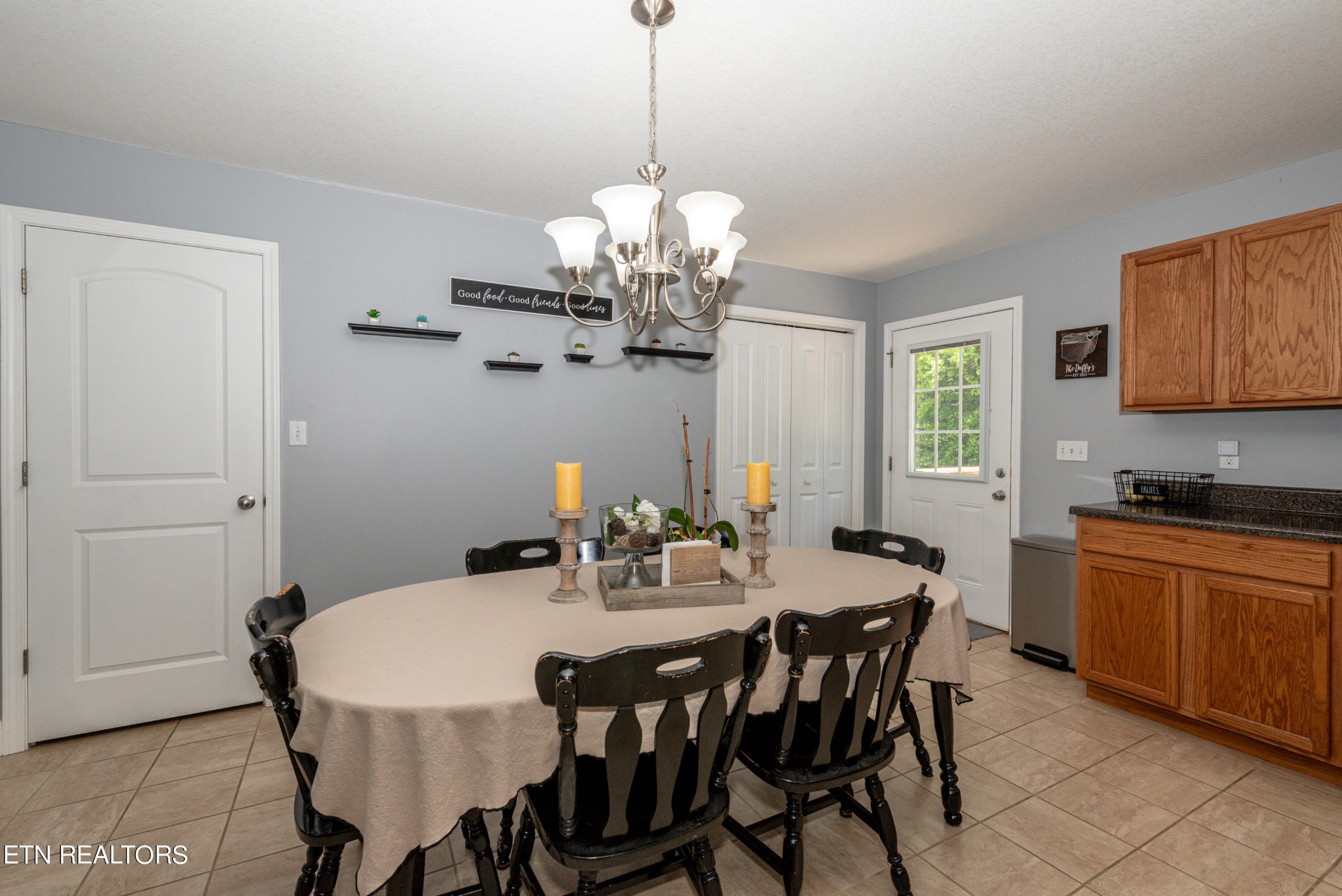 1303 Houston Springs Road Greenback, TN 37742 - Photo 16 of 31 a view of a dining room with furniture a chandelier and wooden floor