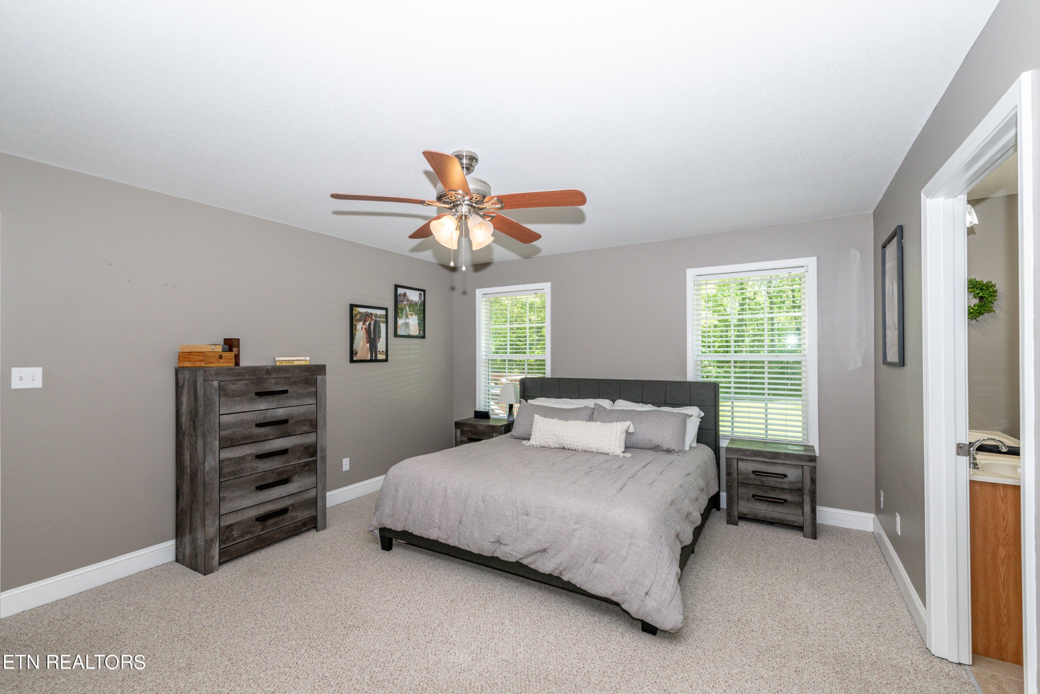 1303 Houston Springs Road Greenback, TN 37742 - Photo 19 of 31 a bedroom with a bed and a chandelier