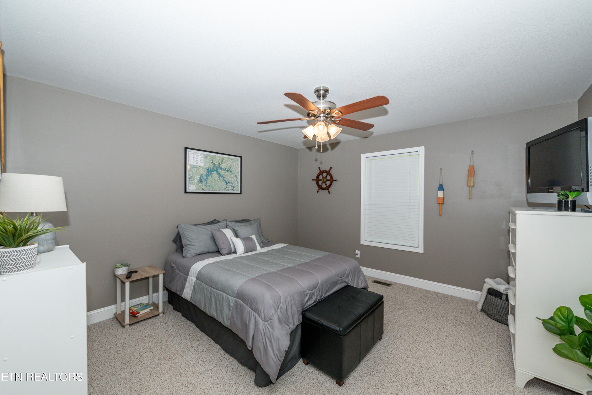 1303 Houston Springs Road Greenback, TN 37742 - Photo 23 of 31 a bedroom with a bed and a chandelier