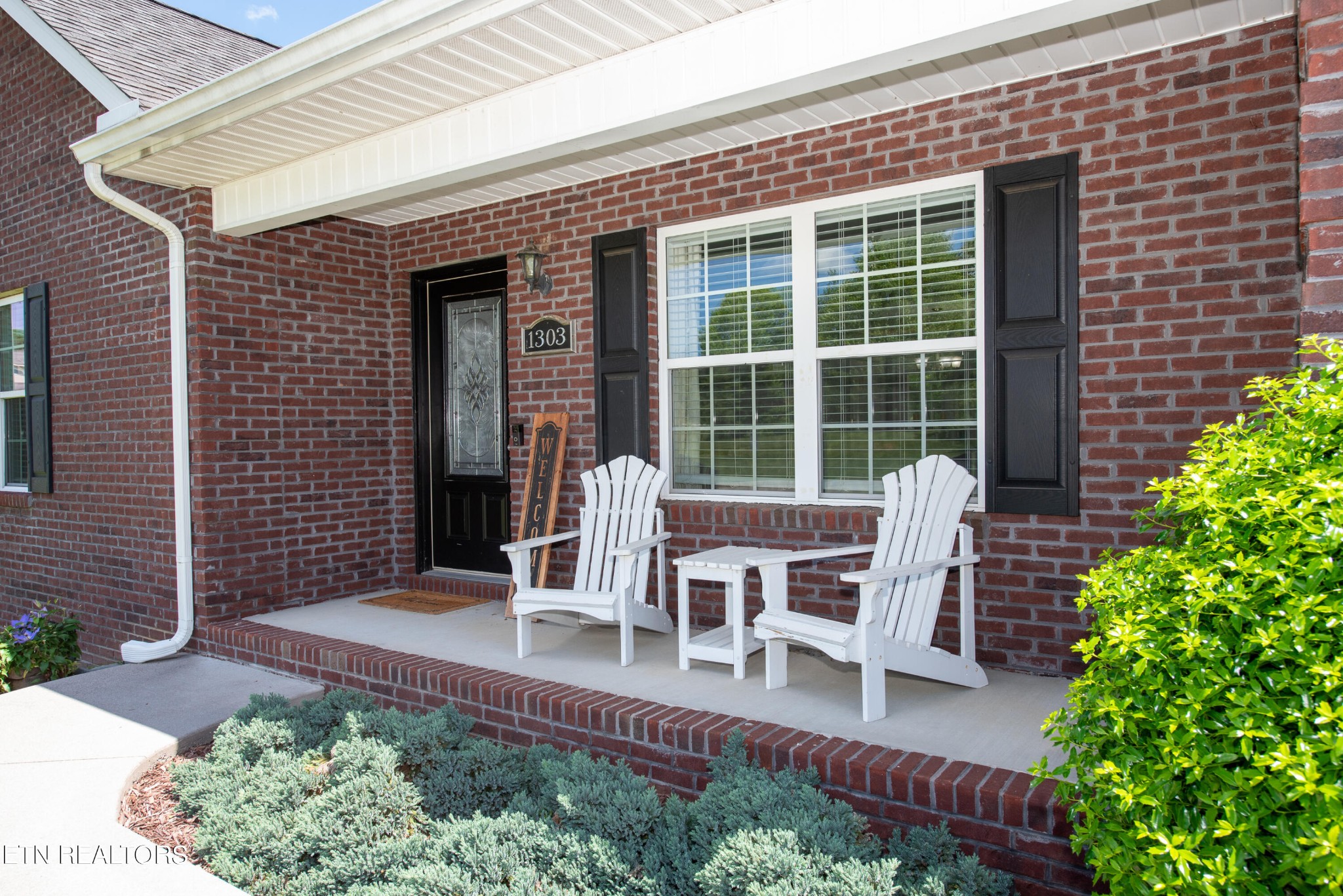 1303 Houston Springs Road Greenback, TN 37742 - Photo 7 of 31 a balcony with table and chairs and potted plants