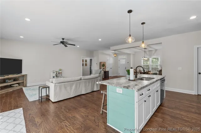 a living room with furniture and kitchen view