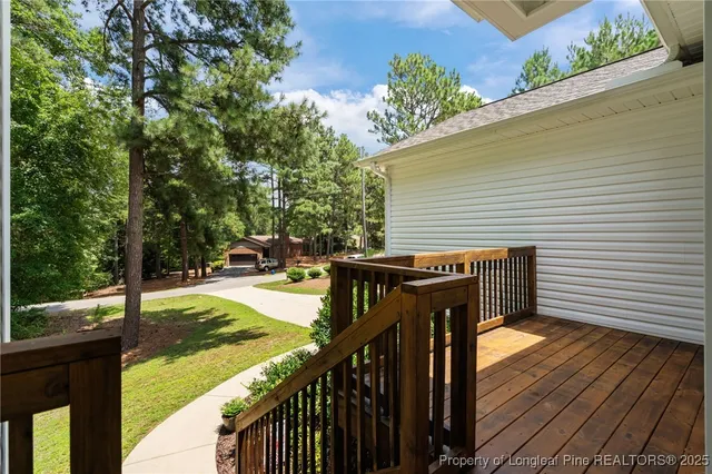 a view of a balcony with wooden floor and fence