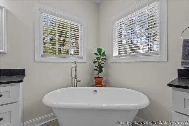 a bathroom with a bathtub sink and mirror