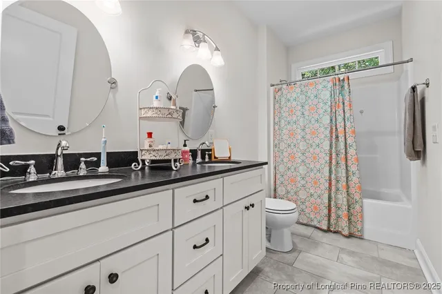 a view of a bedroom with baby crib and lounge chair